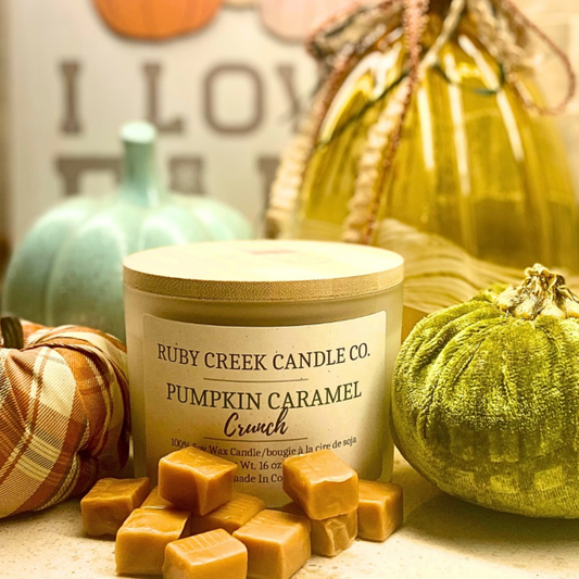 Pumpkin Caramel Crunch Soy Wax Candle - a three wick candle surrounded by pumpkins and caramels